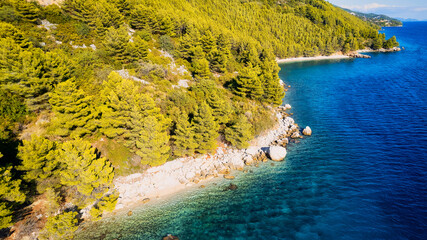 The stunning beauty of Croatia's rocks and forests is captured in this breathtaking aerial view. Take in the turquoise waters and beach from above, and add this travel image to your collection of unfo