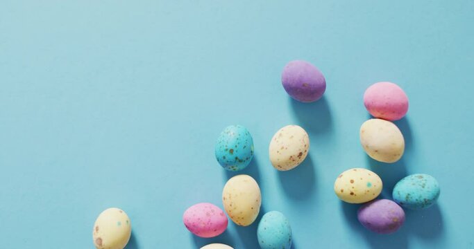 Video of decorated colorful easter eggs on a blue surface
