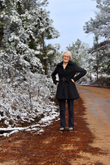 Elderly Woman Enjoys a Winter Stroll on Dirt Road