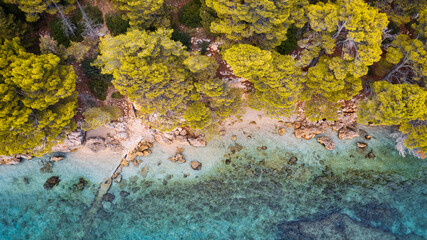 The stunning beauty of Croatia's rocks and forests is captured in this breathtaking aerial view. Take in the turquoise waters and beach from above, and add this travel image to your collection of unfo