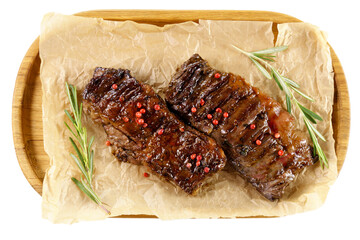 Aged barbecue beef steak close up on wooden background. banner, menu. Isolated on a white background.