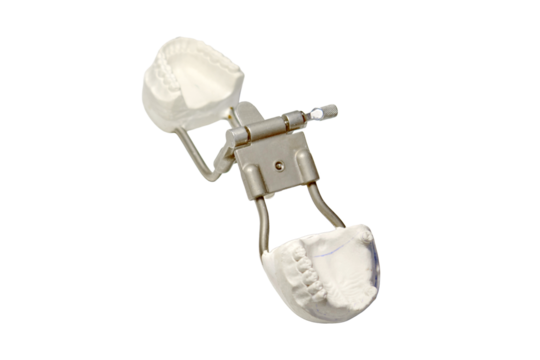 Dentist's tools and a dental impression on the table of the prosthetist's doctor, isolated on a white background