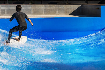 A surfer enjoying the waves provided by an urban wave pool