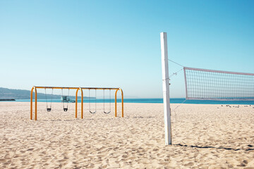 On Hermosa Beach, there are several volleyball nets, a swing set playground and lifeguard towers...