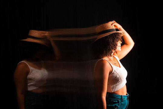 Motion blurred portrait of a woman wearing maron hat