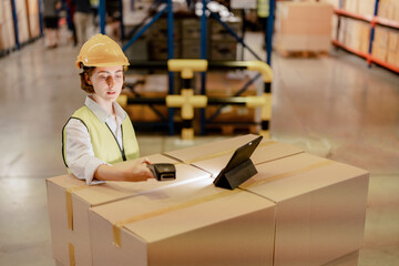 Industrial worker woman wearing safety suite in factory. worker working in warehouse stock...