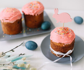 Tasty Easter cake, painted eggs, willow branches and toy bunny on table top view