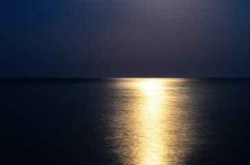 Fototapeta na wymiar reflection of moonlight on the sea surface at night