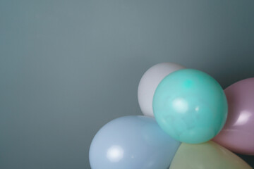 Few Party Balloons Against Grey Background with Free Space