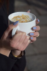 woman holding a cup of coffee
