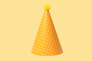Bright and colorful birthday cap isolated on a yellow background.