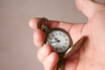 a pocket watch in the hands of a man