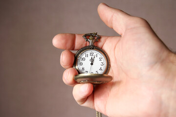 a pocket watch in the hands of a man
