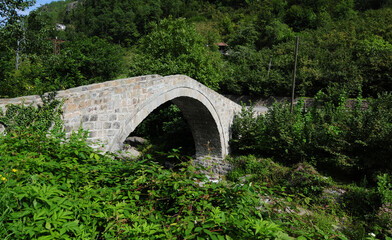 Fototapeta na wymiar The historical December Bridge, located in Artvin, Turkey, was built in the 18th century.