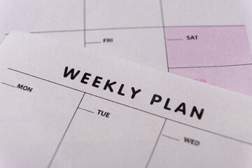 Weekly planner. Calendar reminder, organizer, schedule, planning concept. Close-up of weekly plan paper - obrazy, fototapety, plakaty