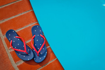 A pair of american flag flip flops 
 by the pool, top view
