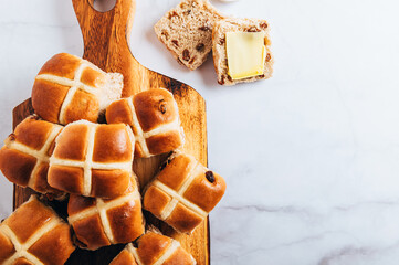 Easter Breakfast with Hot Cross Buns, served on Wooden Chopping Board. Top View