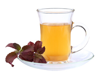 Cup of herbal tea with red tulsi leaves
