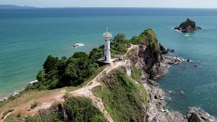 Tilt up drone shot of Koh Lanta lighthouse on sunny day. Mu Ko Lanta National Park, Thailand.
