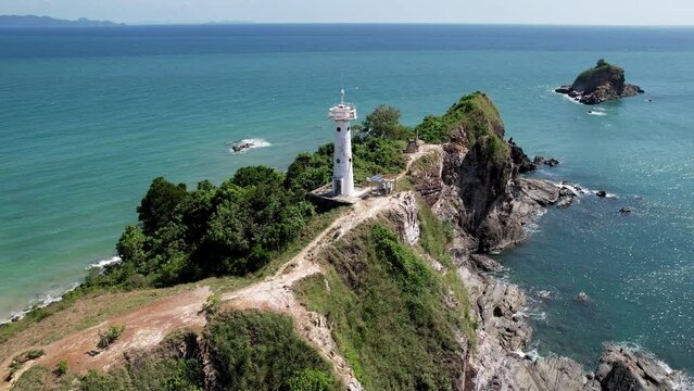 Tilt up drone shot of Koh Lanta lighthouse on sunny day. Mu Ko Lanta National Park, Thailand.