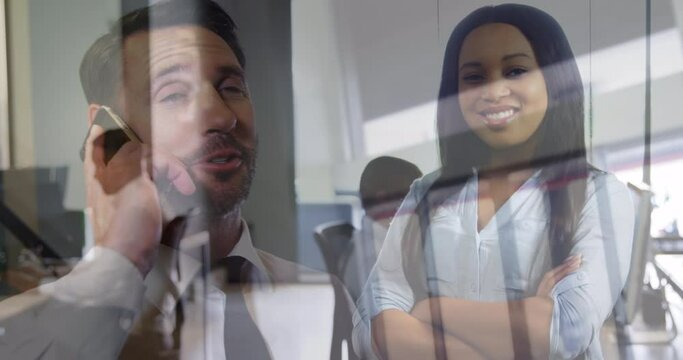 Animation of caucasian man with smartphone over biracial businesswoman in office