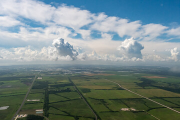 9/6/2022:   Texas, USA - An aerial view of clouds over the farmlands of Eastern Texas near Houston.