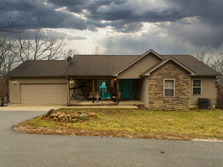 Fototapeta na wymiar View of a typical suburban house with a stormy sky