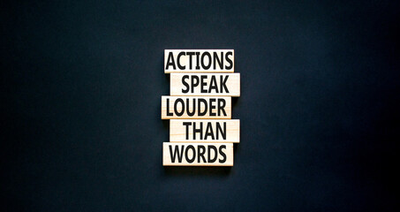 Actions speak louder words symbol. Concept words Actions speak louder than words on wooden blocks....