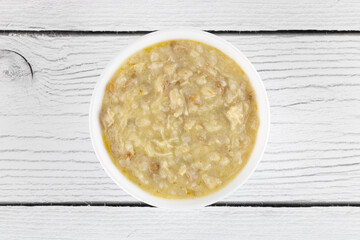 Armenian porridge - harissa with chicken on white background. Top view. Armenian cuisine.