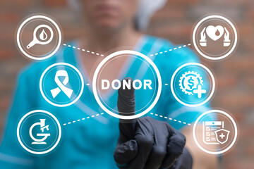Doctor using virtual touchscreen presses word: DONOR. Blood donation concept. Blood and plasma...