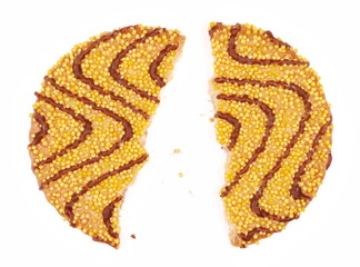 Cookies broken, pieces with milk chocolate drizzle, yellow sprinkles and butter isolated on white, top view