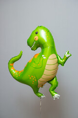 green dinosaur hot air balloon on gray background