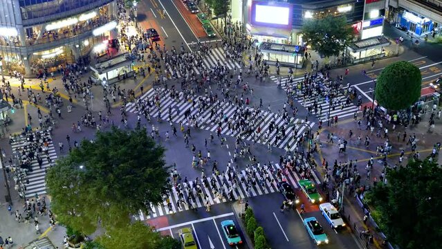 Looking down at thousands of people crossing the famous Shibuya crosswalk in Tokyo Japan