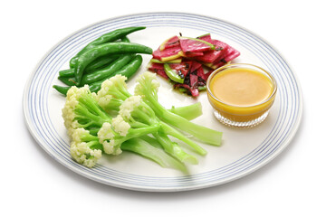 Three kinds of vegetable salad; baby stick cauliflower, watermelon radish, and snap peas