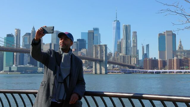 Afro-Americam Man takes photos of the Manhattan Skyline - travel photography