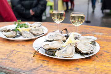 degustation plates with fresh oysters on farmer market in Parice, France