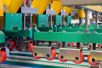 Colorful detail of an equipment fitted with belts and pulleys