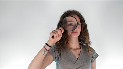 Young girl holding a magnifying glass