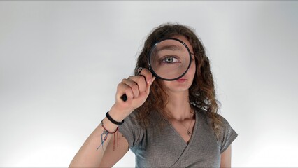 Young girl holding a magnifying glass