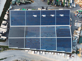 Directly above - Solar panels covering the entire roof of industrial warehouse 