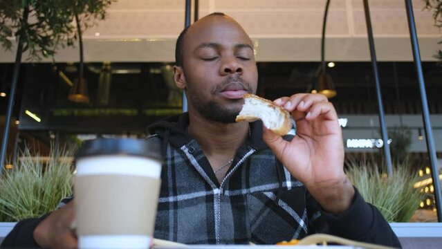 Black Man Eating Lunch In A Cafe