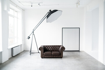 Interior of a photo studio. Leather sofa and studio equipment