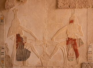 Luxor, Egypt. Pharaoh Hatshepsut mortuary temple wall with ancient painting.