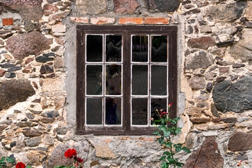Fototapeta na wymiar An old wooden window with glass, a fragment of an old manor.