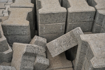 Paving slabs stacked in a pile, road repair process, close-up, selective focus on tiles, seasonal reconstruction of pavement in walking paths in parks