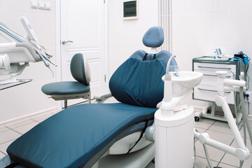 Close-up of dental equipment in dentistry clinic. Workplace and tools of dentists. Dental chair and surgical instruments
