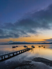 Obraz premium Soft and hazy aerial sunrise waterscape with boats