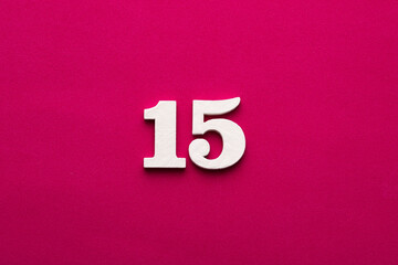Number 15 - White wooden number on rhodamine red background