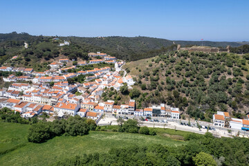 Fototapeta premium Aljezur village in Costa Vicentina. View to the old small town of Aljezur with traditional portuguese houses and rural landscape in Algarve, Portugal.