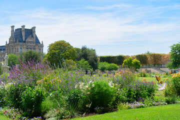 Fototapeta na wymiar Summer holidays in Paris. Tuileries gardens in front of Louvre palace, Paris France.